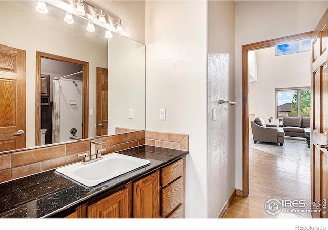 13971 Telluride Dr, Broomfield, CO 80020 - bathroom featuring wood finished floors, curtained shower, vanity, and baseboards