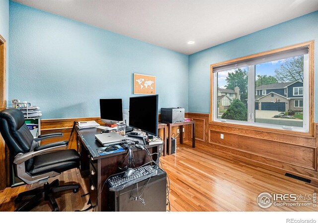 13971 Telluride Dr, Broomfield, CO 80020 - home office with wood finished floors, a wainscoted wall, and wood walls