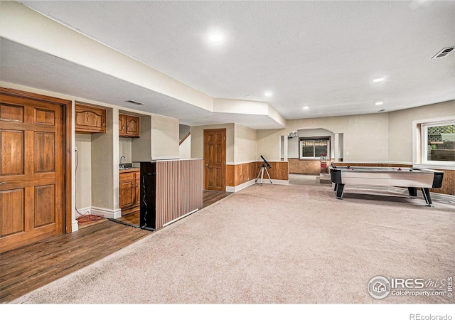 13971 Telluride Dr, Broomfield, CO 80020 - playroom with wainscoting, recessed lighting, bar, dark colored carpet, and arched walkways