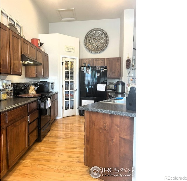 368 Mt Bross Ave, Severance, CO 80550 - kitchen featuring black appliances, under cabinet range hood, dark countertops, and light wood-type flooring