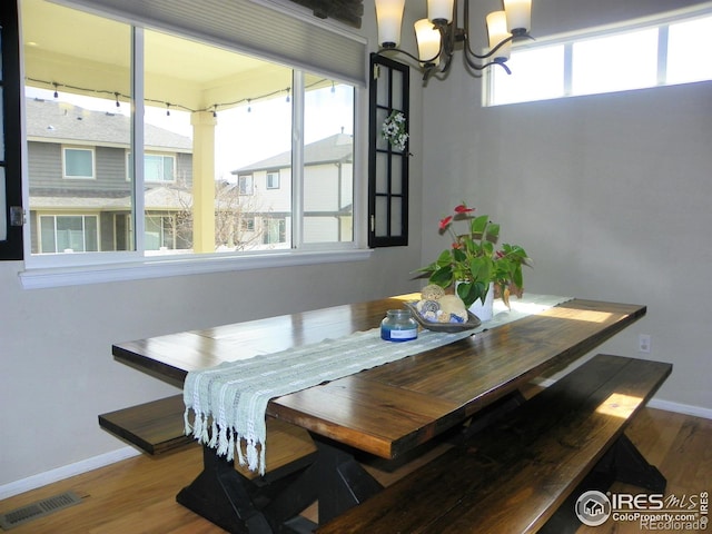 368 Mt Bross Ave, Severance, CO 80550 - dining space with a chandelier, wood finished floors, and baseboards