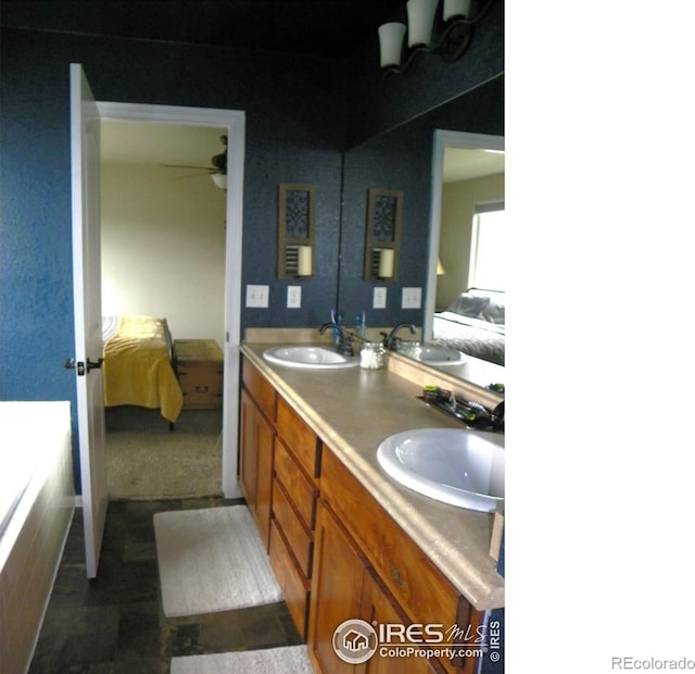 368 Mt Bross Ave, Severance, CO 80550 - bathroom featuring connected bathroom, double vanity, a bathtub, and ceiling fan
