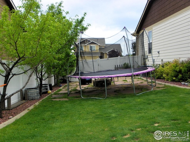 368 Mt Bross Ave, Severance, CO 80550 - view of green lawn featuring a trampoline and central AC unit