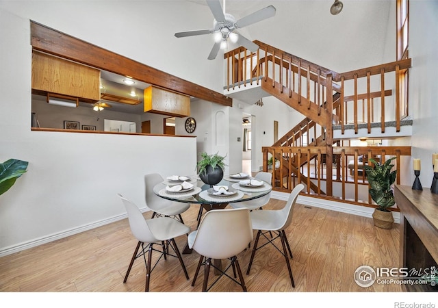 4118 Dillon Way, Fort Collins, CO 80526 - dining room featuring wood finished floors, stairs, high vaulted ceiling, ceiling fan, and baseboards