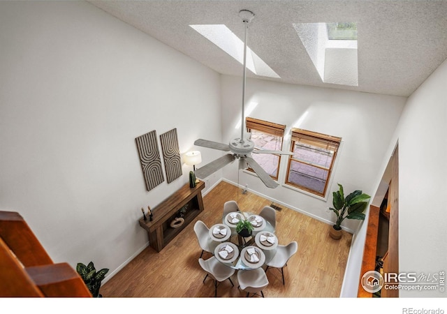 4118 Dillon Way, Fort Collins, CO 80526 - living area featuring a skylight, baseboards, wood finished floors, a textured ceiling, and ceiling fan