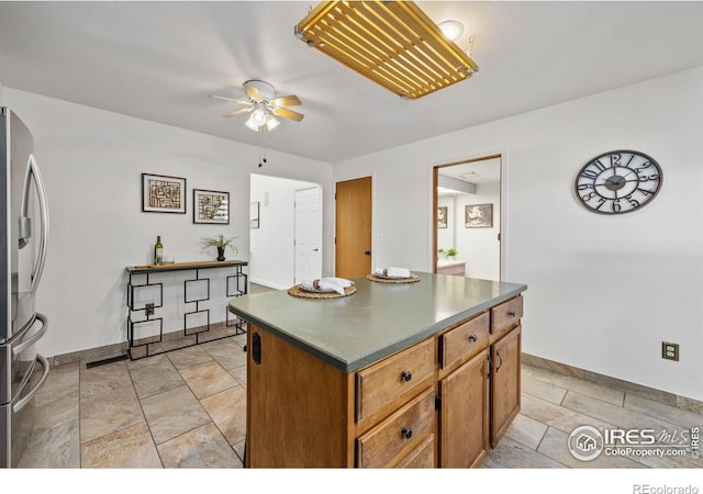 4118 Dillon Way, Fort Collins, CO 80526 - kitchen featuring stainless steel fridge, a ceiling fan, baseboards, and brown cabinets
