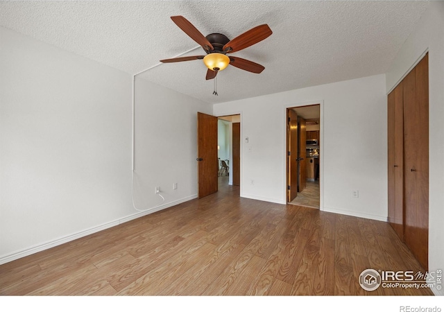 4118 Dillon Way, Fort Collins, CO 80526 - unfurnished bedroom featuring a textured ceiling, wood finished floors, baseboards, ensuite bathroom, and ceiling fan