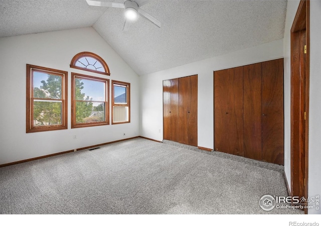 4118 Dillon Way, Fort Collins, CO 80526 - unfurnished bedroom with carpet flooring, multiple closets, vaulted ceiling, a textured ceiling, and baseboards