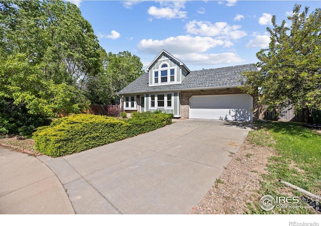 4118 Dillon Way, Fort Collins, CO 80526 - view of front facade with concrete driveway, brick siding, an attached garage, and a shingled roof