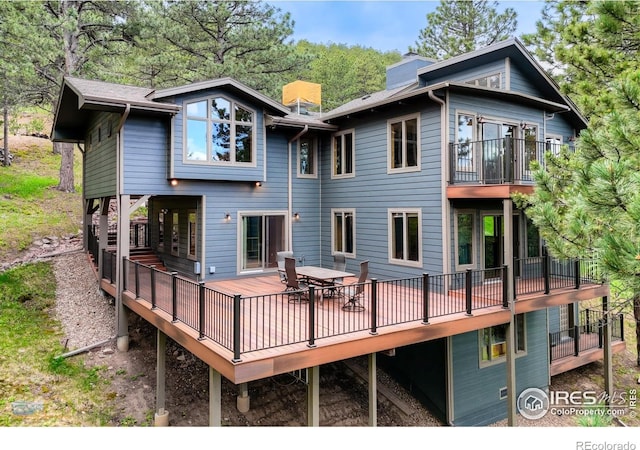 335 Pine Tree Ln, Boulder, CO 80304 - back of property featuring a deck and a chimney