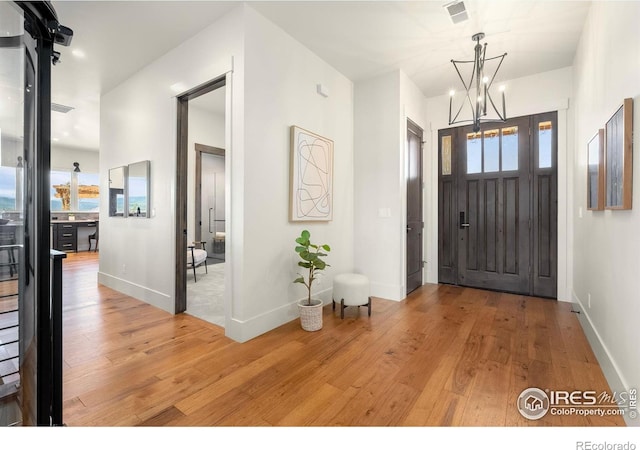 2387 Harding Park Ct, Berthoud, CO 80513 - foyer featuring light wood-style floors, a chandelier, and baseboards