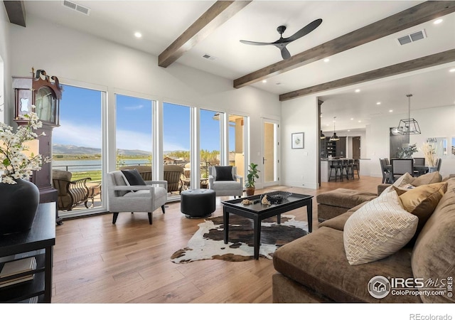 2387 Harding Park Ct, Berthoud, CO 80513 - living room with a ceiling fan, beamed ceiling, light wood-style flooring, plenty of natural light, and a water view