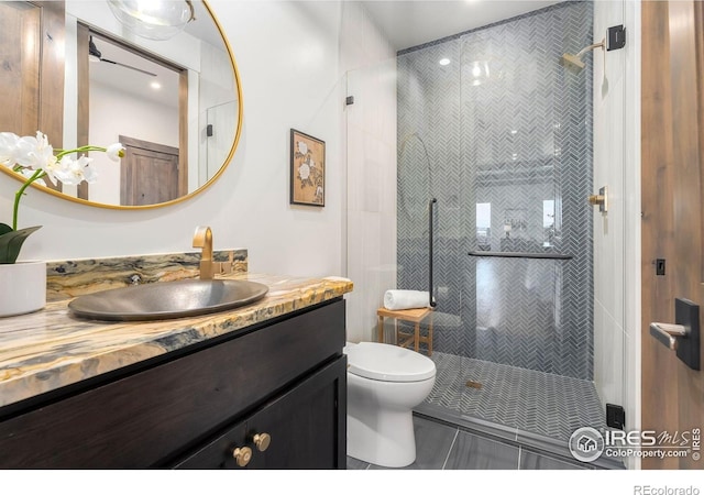2387 Harding Park Ct, Berthoud, CO 80513 - bathroom featuring a shower stall, vanity, toilet, tile patterned flooring, and recessed lighting