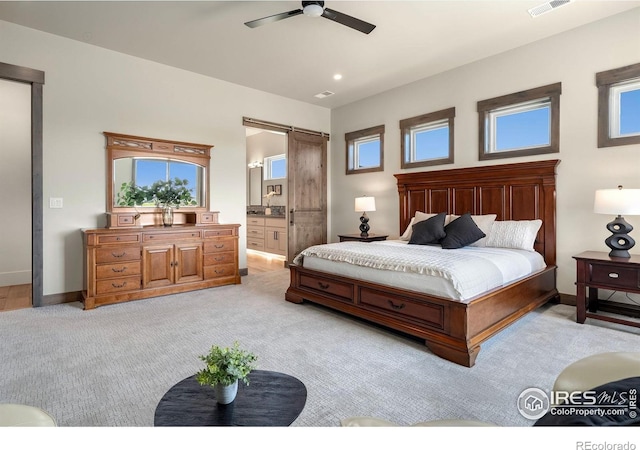 2387 Harding Park Ct, Berthoud, CO 80513 - bedroom featuring a barn door, light colored carpet, baseboards, and ensuite bath