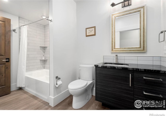 2387 Harding Park Ct, Berthoud, CO 80513 - bathroom featuring wood finished floors, toilet, vanity, shower / bathtub combination with curtain, and baseboards