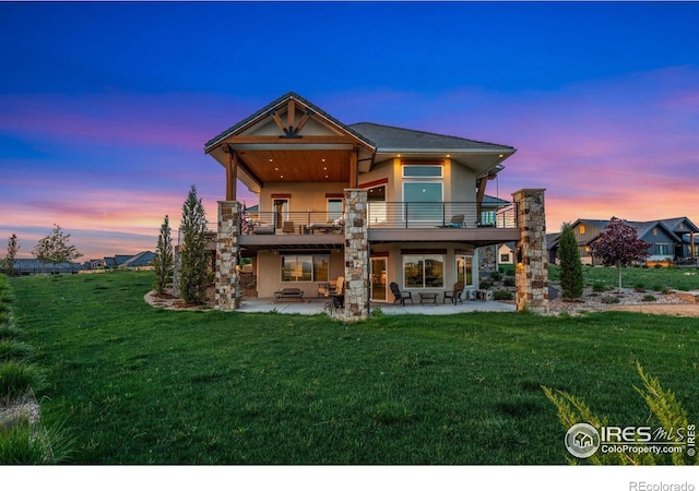 2387 Harding Park Ct, Berthoud, CO 80513 - rear view of property with stucco siding, a patio area, a balcony, and a yard