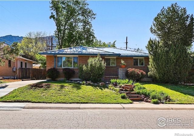 325 Colgate St, Boulder, CO 80305 - view of front of house with a mountain view, brick siding, metal roof, and a standing seam roof