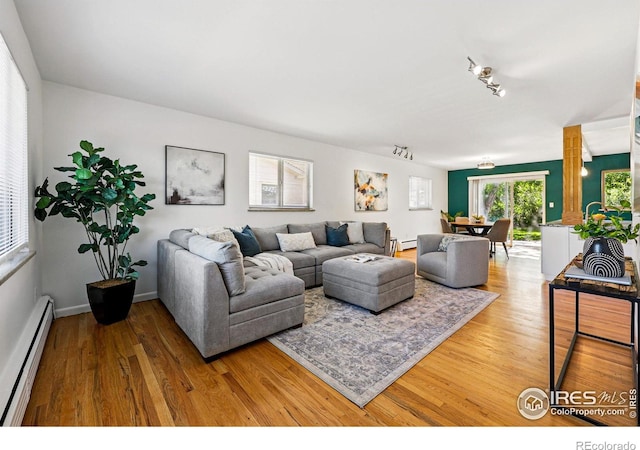 325 Colgate St, Boulder, CO 80305 - living room featuring a baseboard radiator, wood finished floors, and baseboard heating