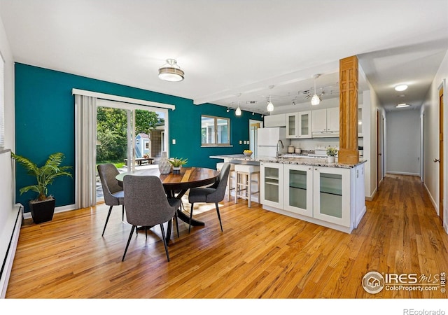 325 Colgate St, Boulder, CO 80305 - dining space with light wood-type flooring, track lighting, a baseboard radiator, and baseboards