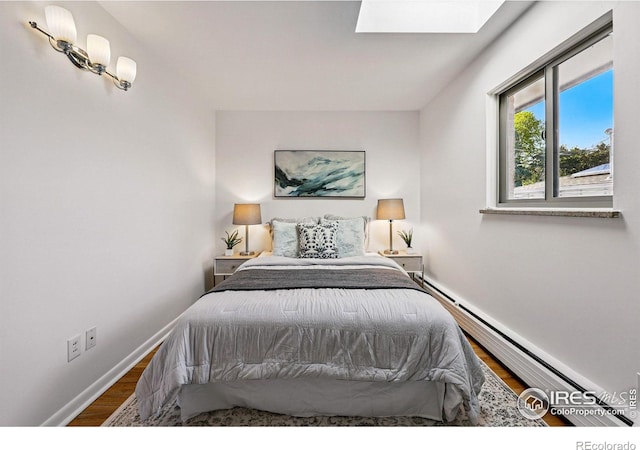 325 Colgate St, Boulder, CO 80305 - bedroom with a skylight, wood finished floors, baseboards, and a baseboard radiator