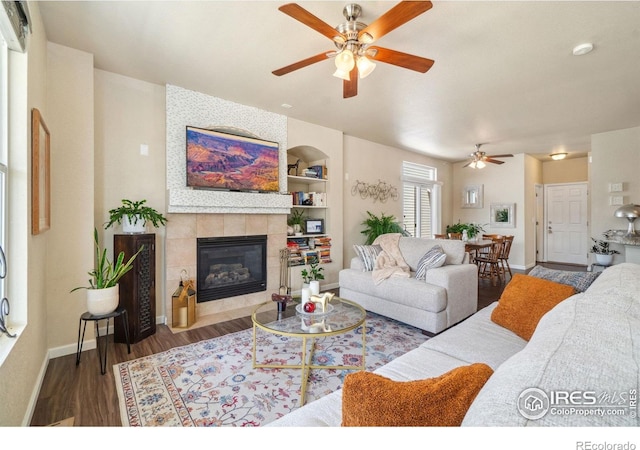 2320 Clipper Way, Fort Collins, CO 80524 - living room with a ceiling fan, wood finished floors, a fireplace, and baseboards