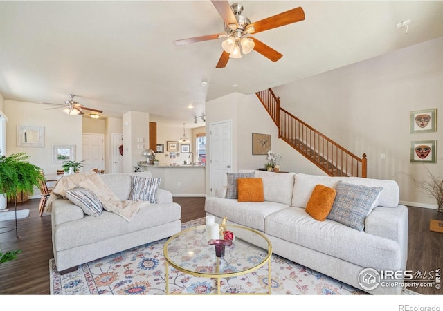 2320 Clipper Way, Fort Collins, CO 80524 - living area featuring ceiling fan, wood finished floors, stairway, and baseboards
