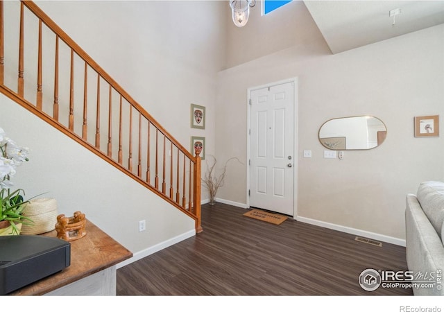 2320 Clipper Way, Fort Collins, CO 80524 - foyer entrance with wood finished floors, baseboards, stairway, and a high ceiling