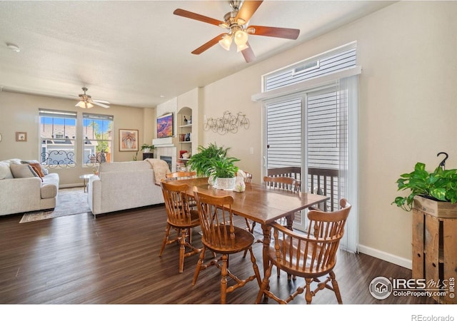2320 Clipper Way, Fort Collins, CO 80524 - dining area featuring ceiling fan, dark wood-style floors, a tile fireplace, and baseboards