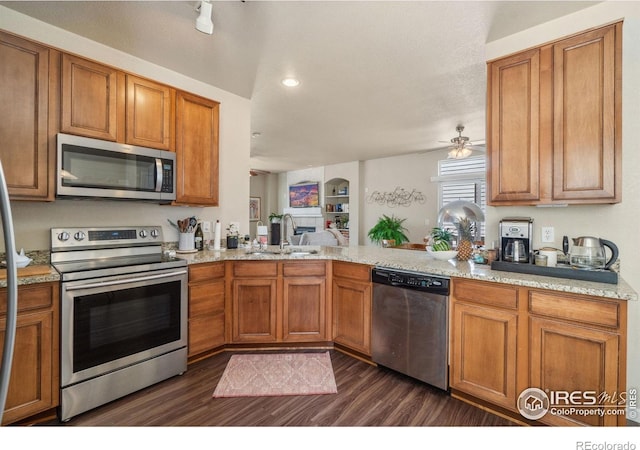 2320 Clipper Way, Fort Collins, CO 80524 - kitchen with appliances with stainless steel finishes, a sink, dark wood-style flooring, brown cabinetry, and recessed lighting