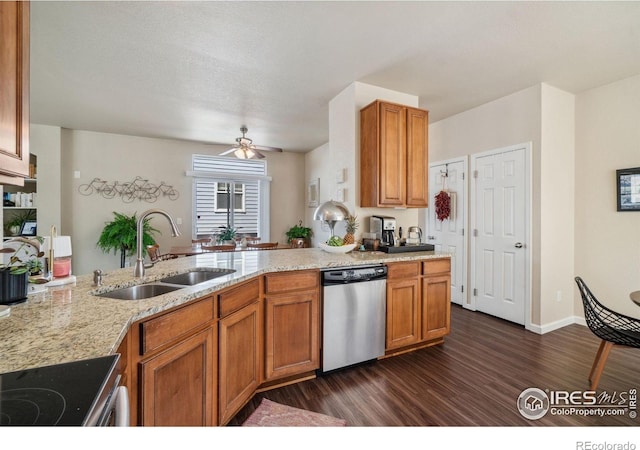 2320 Clipper Way, Fort Collins, CO 80524 - kitchen featuring stainless steel dishwasher, a sink, dark wood-style flooring, and brown cabinetry