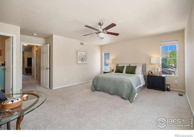 2320 Clipper Way, Fort Collins, CO 80524 - bedroom with light carpet, baseboards, and a ceiling fan