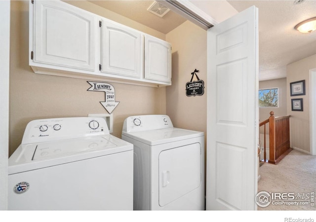 2320 Clipper Way, Fort Collins, CO 80524 - washroom featuring independent washer and dryer, cabinet space, light carpet, and a textured ceiling