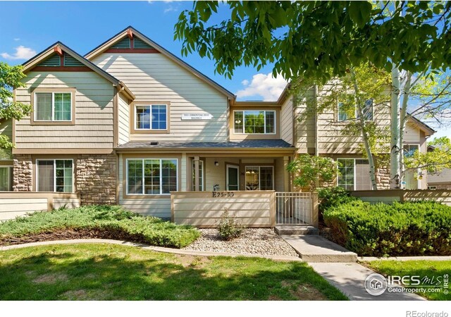 5551 Cornerstone Dr Unit 26, Fort Collins, CO 80528 - view of front of property featuring stone siding and a gate
