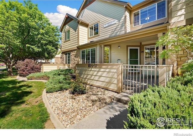 5551 Cornerstone Dr Unit 26, Fort Collins, CO 80528 - view of front facade featuring covered porch and stone siding