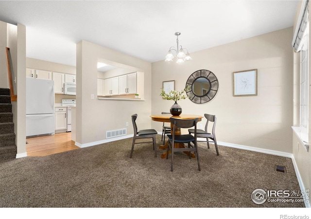 5551 Cornerstone Dr Unit 26, Fort Collins, CO 80528 - carpeted dining area with stairs, a chandelier, and baseboards