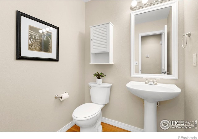 5551 Cornerstone Dr Unit 26, Fort Collins, CO 80528 - bathroom with baseboards, toilet, and wood finished floors