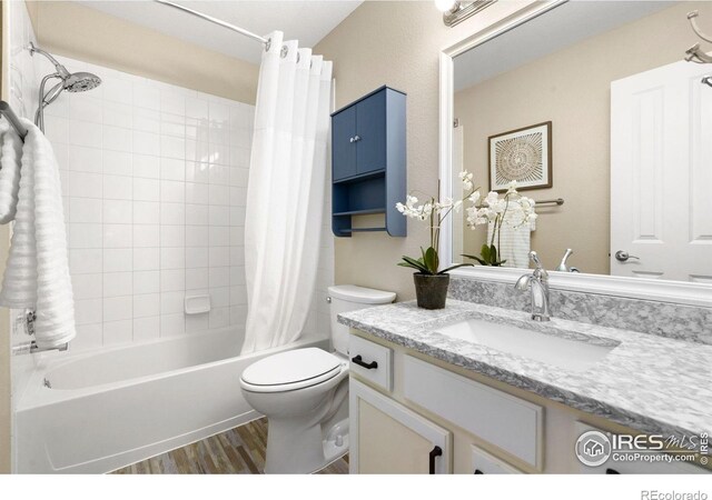 5551 Cornerstone Dr Unit 26, Fort Collins, CO 80528 - bathroom featuring wood finished floors, toilet, vanity, and shower / bath combo with shower curtain