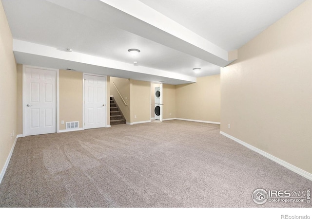 5551 Cornerstone Dr Unit 26, Fort Collins, CO 80528 - finished below grade area with stacked washer / drying machine, baseboards, stairway, and carpet flooring