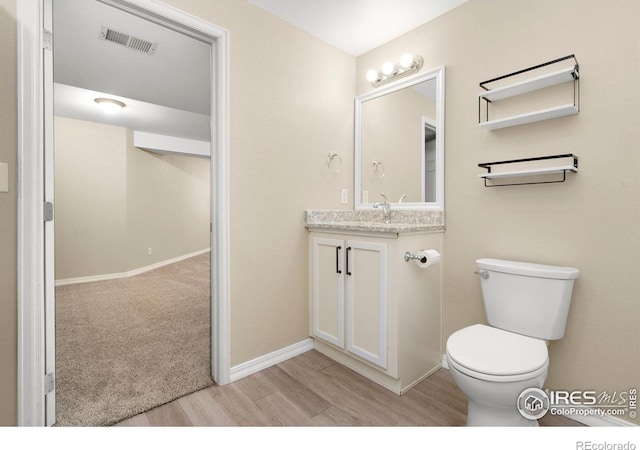 5551 Cornerstone Dr Unit 26, Fort Collins, CO 80528 - bathroom with wood finished floors, toilet, vanity, and baseboards