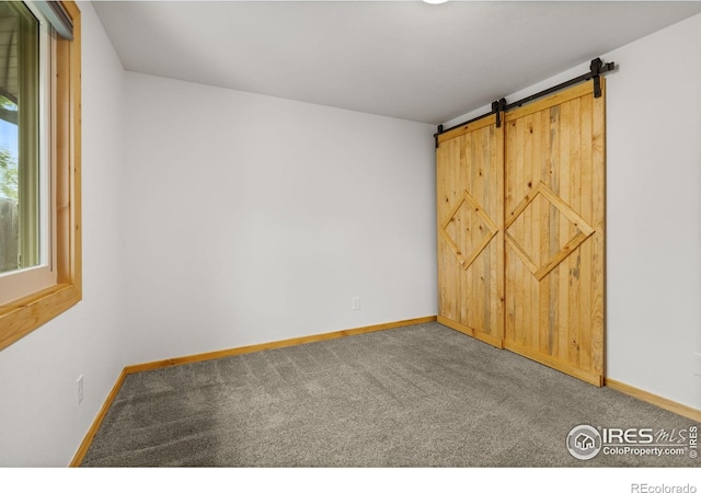 1805 Kinnikinnik Pl, Loveland, CO 80537 - carpeted empty room featuring baseboards and a barn door