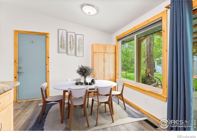 1805 Kinnikinnik Pl, Loveland, CO 80537 - dining space featuring wood finished floors, vaulted ceiling, and baseboards