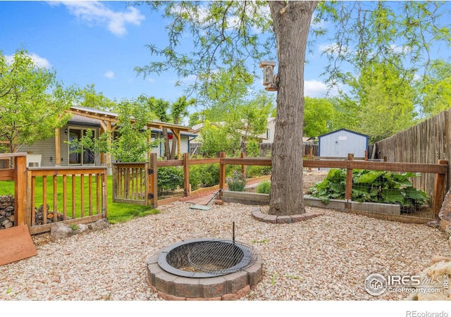1805 Kinnikinnik Pl, Loveland, CO 80537 - fenced yard with a garden and an outdoor fire pit