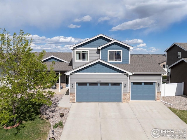 6848 Pettigrew St, Wellington, CO 80549 - craftsman inspired home with stone siding, a garage, concrete driveway, and roof with shingles