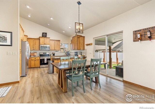 6848 Pettigrew St, Wellington, CO 80549 - kitchen featuring appliances with stainless steel finishes, light wood-style floors, baseboards, healthy amount of natural light, and lofted ceiling