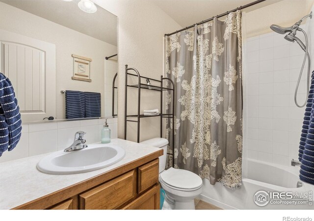 6848 Pettigrew St, Wellington, CO 80549 - bathroom featuring decorative backsplash, toilet, shower / bathtub combination with curtain, and vanity