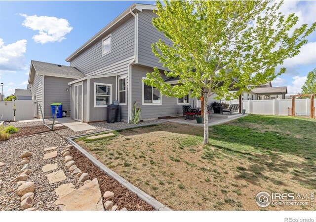 6848 Pettigrew St, Wellington, CO 80549 - rear view of property with a patio area and a gate