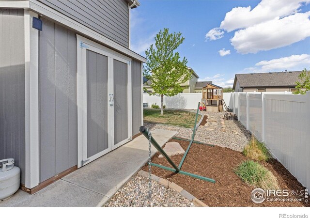 6848 Pettigrew St, Wellington, CO 80549 - fenced backyard with a playground and an outdoor structure