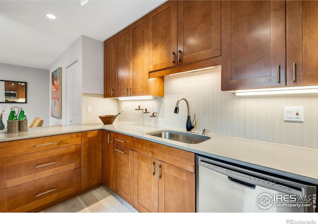 4795 Tantra Dr, Boulder, CO 80305 - kitchen featuring appliances with stainless steel finishes, a sink, light countertops, brown cabinets, and recessed lighting