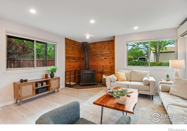 4795 Tantra Dr, Boulder, CO 80305 - living area with a wood stove, wood finished floors, recessed lighting, and a wall mounted AC