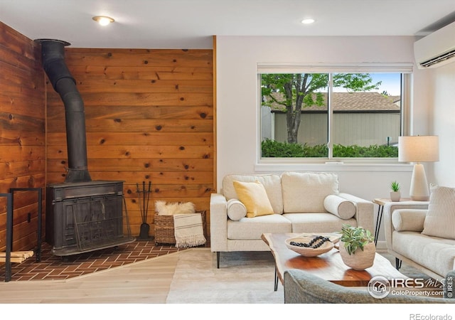 4795 Tantra Dr, Boulder, CO 80305 - living room with an AC wall unit, a wood stove, recessed lighting, and wood finished floors